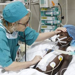Staff visiting a patient in the ICU of the Salam Centre for Cardiac Surgery, Khartoum